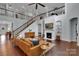 Elegant living room featuring a fireplace, staircase, and an upper level loft area at 1355 Cilantro Ct, Fort Mill, SC 29708