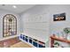 Well-organized mudroom area with bench, storage baskets, and decorative mirror at 1355 Cilantro Ct, Fort Mill, SC 29708