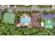 Aerial view of community pool, tennis courts, and clubhouse nestled among mature trees and landscaped grounds at 1355 Cilantro Ct, Fort Mill, SC 29708