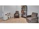Cozy room with gray accent chairs, a miniature kitchen set and a rustic bookshelf at 1355 Cilantro Ct, Fort Mill, SC 29708