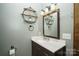 Bathroom with vanity, mirror with wall sconce, round decorative shelf, toilet, and paper holder at 1565 Earnhardt Rd, Salisbury, NC 28146