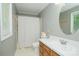 Bathroom featuring wood vanity, white countertop, single sink, white toilet and shower/tub combo with curtain at 1565 Earnhardt Rd, Salisbury, NC 28146