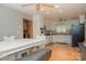 Bright kitchen and adjacent dining area featuring appliances and white cabinetry at 1565 Earnhardt Rd, Salisbury, NC 28146
