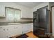 Well-equipped kitchen with a stainless steel refrigerator and white cabinetry at 1565 Earnhardt Rd, Salisbury, NC 28146