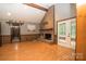 Living room featuring brick fireplace, wood floors, and access to the sunroom at 1565 Earnhardt Rd, Salisbury, NC 28146