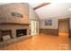 Spacious living room with a large brick fireplace and wood-beamed ceiling at 1565 Earnhardt Rd, Salisbury, NC 28146