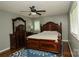 Comfortable main bedroom features a ceiling fan, area rug and a dark wood bedroom set at 1565 Earnhardt Rd, Salisbury, NC 28146