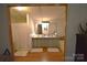 Bright bathroom with double sinks, spacious vanity, and a separate shower and tub area, perfect for relaxation at 1789 Paris Dr, Conover, NC 28613