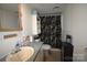Bathroom with a vanity, cabinet, toilet, and shower area with a floral curtain at 1789 Paris Dr, Conover, NC 28613