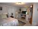 Comfortable bedroom with a patchwork quilt bed, fan, and dresser, creating a cozy and inviting atmosphere at 1789 Paris Dr, Conover, NC 28613