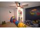 bedroom with dinosaur decor, closet, and a bright play tunnel at 1789 Paris Dr, Conover, NC 28613