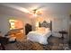 Comfortable bedroom featuring ceiling fan, adjacent bathroom and stylish iron bed frame at 1789 Paris Dr, Conover, NC 28613