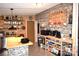Functional coffee bar area with wood shelving, coffee accessories, and decorative stone accent wall at 1789 Paris Dr, Conover, NC 28613