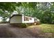 A manufactured home with a brick foundation, features a well-maintained exterior and a large, natural yard at 1789 Paris Dr, Conover, NC 28613