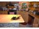 Functional kitchen boasts stainless appliances, wood cabinets, and a stone detailed island at 1789 Paris Dr, Conover, NC 28613