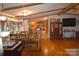 Open-concept living and dining area with hardwood floors and large windows, offering a bright and inviting space at 1789 Paris Dr, Conover, NC 28613