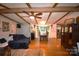 Spacious living room features wood beams, hardwood floors, and a dining area, perfect for entertaining guests at 1789 Paris Dr, Conover, NC 28613
