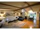 Inviting living room features exposed beams, hardwood floors, and a comfortable seating arrangement, perfect for gatherings at 1789 Paris Dr, Conover, NC 28613
