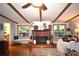 Cozy living room with hardwood floors, a fireplace, and bench seating under a window, creating a warm and inviting space at 1789 Paris Dr, Conover, NC 28613