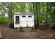 Well-maintained shed with double doors and flower boxes nestled in a wooded setting at 1789 Paris Dr, Conover, NC 28613