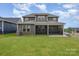 A lush green backyard featuring a covered patio, providing the perfect outdoor oasis at 1818 Winding Mist Dr, Belmont, NC 28012