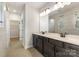 Elegant bathroom featuring dual vanities, modern lighting, and a walk-in shower at 1818 Winding Mist Dr, Belmont, NC 28012
