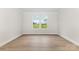 Bright bedroom featuring wood floors, a large window, and neutral wall colors at 1818 Winding Mist Dr, Belmont, NC 28012