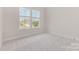 Bright bedroom featuring carpet floors, two large windows, and neutral wall colors at 1818 Winding Mist Dr, Belmont, NC 28012