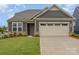Charming single-Gathering home with a manicured lawn, neutral siding, and an attached two car garage at 1818 Winding Mist Dr, Belmont, NC 28012