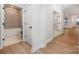 Bright hallway showcasing hardwood floors, crisp white trim and doors leading to the bathroom at 1818 Winding Mist Dr, Belmont, NC 28012