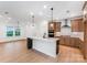 Bright, open kitchen with a large island, stainless steel appliances, and modern cabinetry at 1818 Winding Mist Dr, Belmont, NC 28012