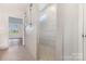 Bathroom shower highlighted by decorative tiling and bright lighting with hexagon flooring at 1818 Winding Mist Dr, Belmont, NC 28012