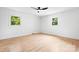 Minimalist bedroom with light wood floors, two windows and white walls at 201 Forest Rd, Taylorsville, NC 28681