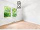 Empty dining room features light walls, gray floors, and natural light from the windows at 201 Forest Rd, Taylorsville, NC 28681