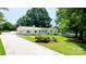 Charming single-story home with white exterior, manicured lawn, and long driveway at 201 Forest Rd, Taylorsville, NC 28681