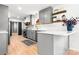 Modern kitchen featuring gray cabinets, stainless steel appliances, and light wood floor at 201 Forest Rd, Taylorsville, NC 28681