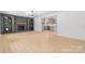Spacious living room with a brick fireplace, built-in shelving, and light-colored flooring at 201 Forest Rd, Taylorsville, NC 28681