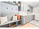 Well-organized mudroom with built-in storage, bench, and gray cabinetry with a sink at 201 Forest Rd, Taylorsville, NC 28681