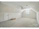 A spacious attic with an angled ceiling, a ceiling fan, and carpeted floors at 201 Limerick Dr, Matthews, NC 28104