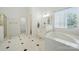 Elegant bathroom with soaking tub, vanity, and tiled floor offering a luxurious spa-like experience at 201 Limerick Dr, Matthews, NC 28104