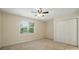 Bright bedroom with a ceiling fan, window with blinds and a double door closet at 201 Limerick Dr, Matthews, NC 28104