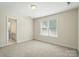 Carpeted bedroom featuring natural light, and neutral tones offering a peaceful retreat at 201 Limerick Dr, Matthews, NC 28104