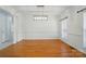 Spacious dining room with hardwood floors, decorative lighting, and large windows at 201 Limerick Dr, Matthews, NC 28104