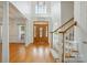 Bright foyer with hardwood floors, staircase, and large windows, creating an elegant entrance at 201 Limerick Dr, Matthews, NC 28104
