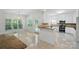 Bright kitchen with white cabinetry, tile floors, and breakfast nook area at 201 Limerick Dr, Matthews, NC 28104