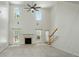 Open concept living room with fireplace, high ceilings, and abundant natural light at 201 Limerick Dr, Matthews, NC 28104