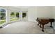 Bright sitting room with large windows and a piano, creating a warm and inviting space at 201 Limerick Dr, Matthews, NC 28104