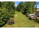 This spacious backyard features a deck, playground, and trampoline at 2021 Tarzi Ln, Charlotte, NC 28215