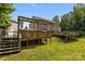 The multi-level decks in the back lead to a covered patio with a grill in the backyard at 2021 Tarzi Ln, Charlotte, NC 28215