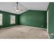 Bedroom with two bright windows, green walls, and neutral carpet at 2021 Tarzi Ln, Charlotte, NC 28215